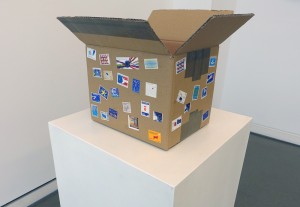 Bill Balaskas, Pandora, 2016, mixed media: carton box, inflatable armband, styrofoam packing peanuts, commemorative EU postage stamps, 33 x 50 x 40 cm